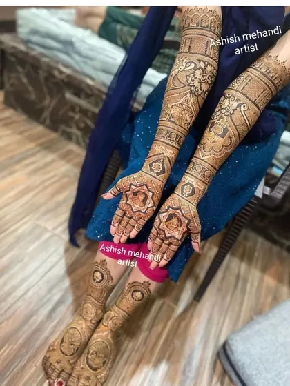 This full-body shot shows how the hand and feet mehandi come together to create a complete, beautiful bridal look.