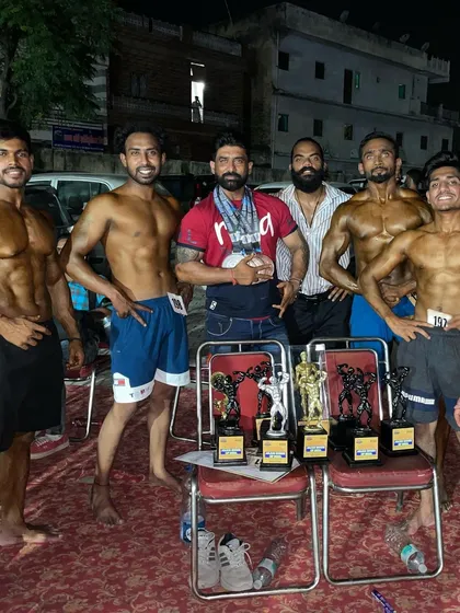The whole team celebrating. I stand with my clients every step of the way, from the first day in the gym to their victory on the competition stage.