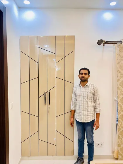 Standing next to the completed two-door geometric wardrobe, a great example of our custom design capabilities.