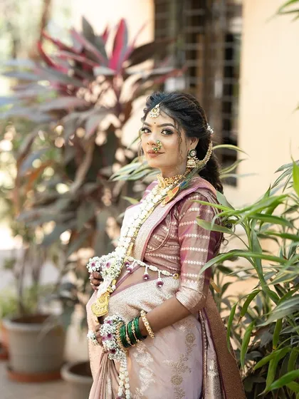 A beautiful portrait of a client wearing a full Dohale Jevan set. The jewellery is designed to complement her features and her traditional attire.