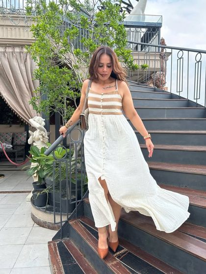 A breezy white and brown maxi dress is perfect for a summer day out. This comfortable yet chic piece from The Clothing Factory is easy to style and perfect for brunch or a casual event.