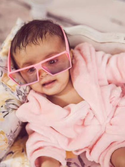 This little diva is living the life. Our spa day theme comes with a tiny pink robe, oversized sunglasses, and mini luggage for a fun, glamorous shoot.