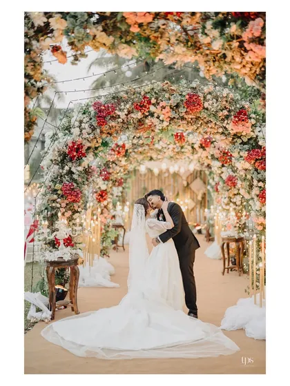 A fairytale moment captured under a breathtaking arch of flowers. We focus on creating grand, romantic portraits that feel both epic and deeply personal, turning your wedding venue into a magical backdrop for your love story.