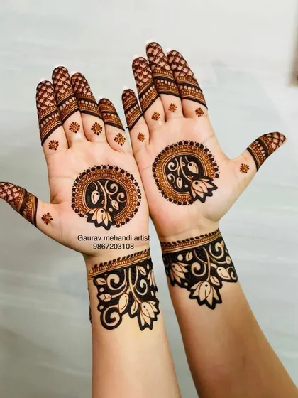 A modern take on the traditional mandala. This design features lotus motifs within a circular pattern on the palm, with a matching cuff design on the wrist, offering a clean and contemporary look.