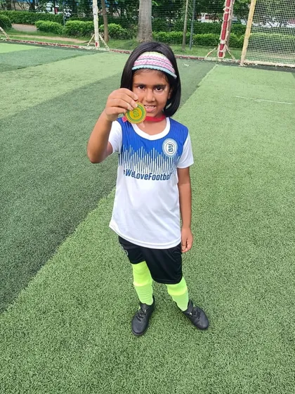 A proud moment for a young player, showing off her medal. This is what sisterhood in sport looks like.