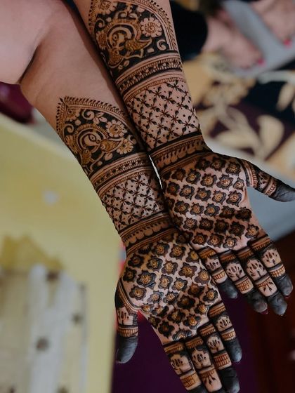 A complete view of the intricate grid and paisley design, showing how the patterns flow from the palm to the arm.