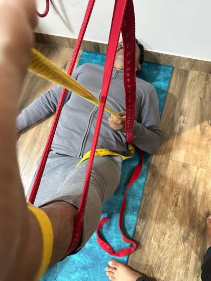 This is a therapeutic traction technique using ropes and belts. It is designed to decompress the hip joint and relieve pressure, which can be highly effective for conditions like sciatica or hip impingement.