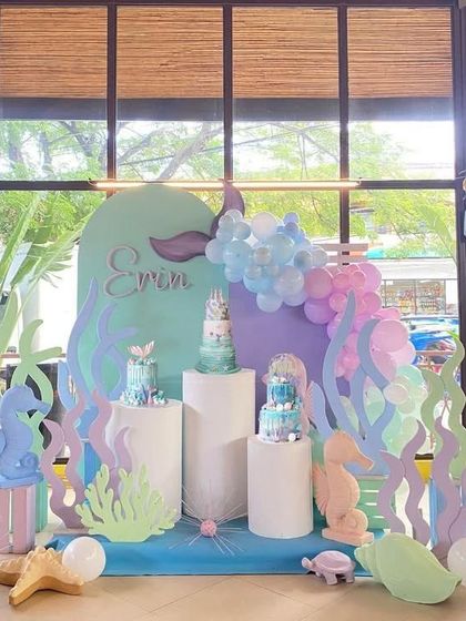 An elaborate underwater scene for a mermaid-themed birthday. We created custom-cut props of coral, seahorses, and a mermaid tail to build a complete and immersive environment for the party.