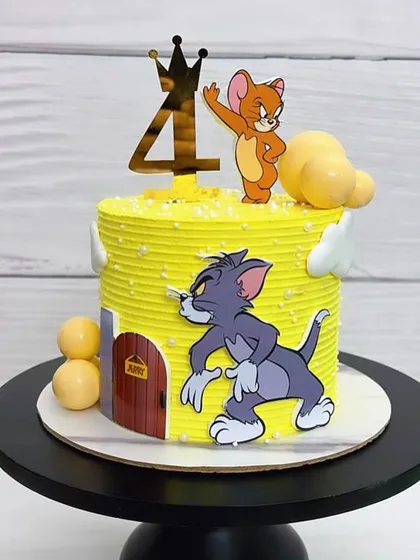 A bright yellow Tom & Jerry cake for a 4th birthday. It’s a classic theme that never gets old and is loved by kids and adults alike.