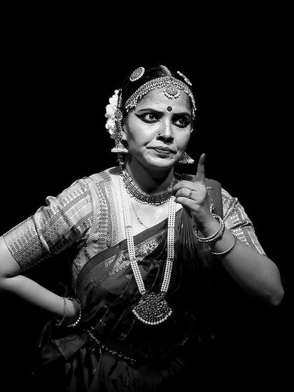 A striking black and white portrait from 'Rasayatra'. The high contrast and dramatic pose emphasize the power and intensity of the dancer's expression.