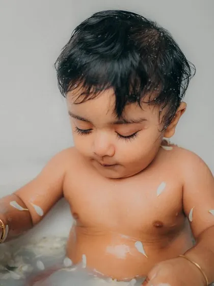 Lost in thought while playing with the flower petals. Tub time sessions result in such natural and beautiful photos.