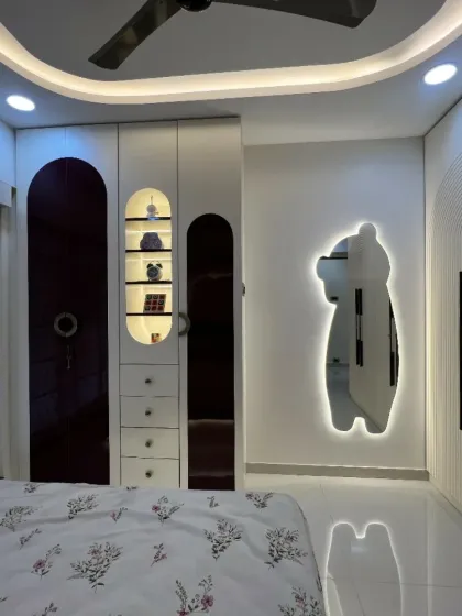 A playful and chic kids' room with a unique bear-shaped backlit mirror and arched wardrobe details, creating a magical and fun environment.