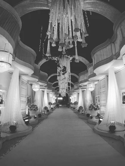 A stunning, grand entrance walkway designed to give your guests a 'wow' experience from the moment they arrive. The combination of architectural arches, elegant draping, and focused lighting creates a path of pure luxury.