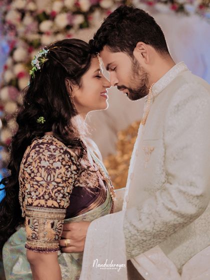 An intimate forehead-to-forehead pose, capturing the deep connection between the couple. The soft lighting and their gentle smiles make this a truly romantic shot.