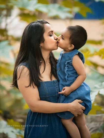 A sweet kiss between mother and child. This close-up shot beautifully captures the affection and tenderness in their relationship during an outdoor family session.