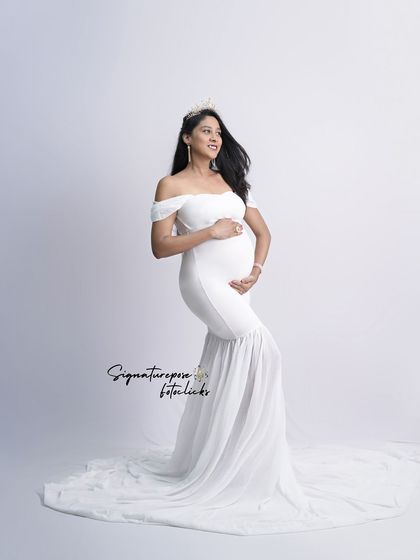 An angelic portrait in a simple white mermaid gown, with a crown adding a touch of royalty.