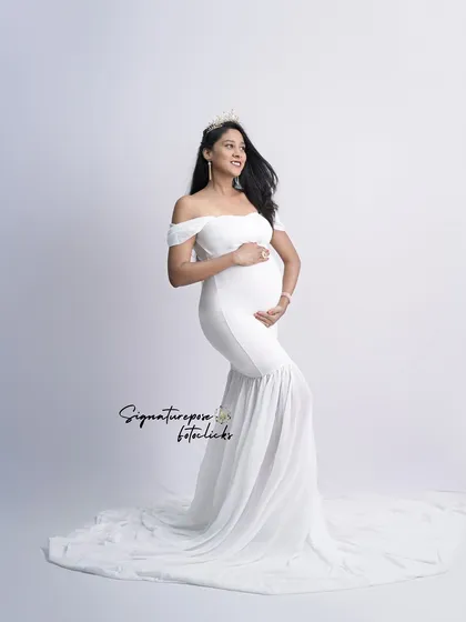 An angelic portrait in a simple white mermaid gown, with a crown adding a touch of royalty.