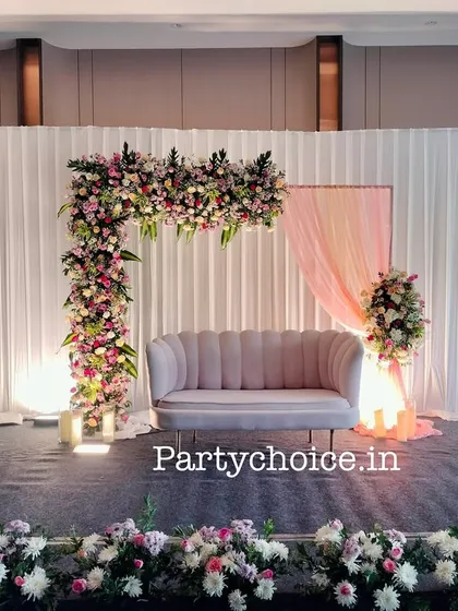 A wide shot of the modern engagement stage, showing how the floral arch, soft lighting, and clean backdrop create a sophisticated look.