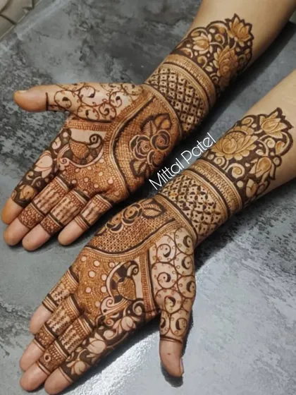 An intricate design combining paisleys, florals, and swirls. This full coverage look is a beautiful example of traditional Indian mehndi art.
