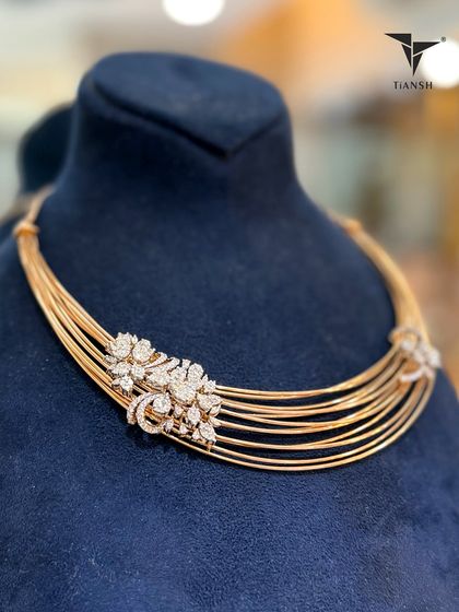This signature multi strand choker in radiant gold tones is crowned with diamond studded florals. Each petal is shaped to catch light and compliments in equal measure.
