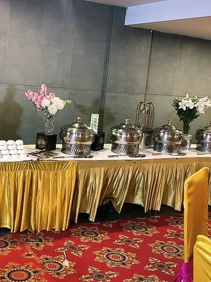A touch of royalty for your special event. This stunning buffet setup combines golden accents with fresh flowers and premium chafing dishes to create a 5-star dining experience for your guests.