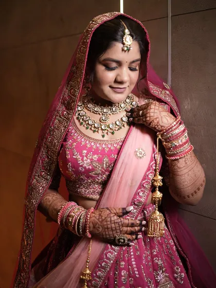The bride adjusting her beautiful jewelry, a moment of quiet elegance before the ceremony.