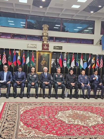 The formal group photograph at DSSC, seated before the flags of participating nations. This image captures the global scope of the training and dialogue at the institution.