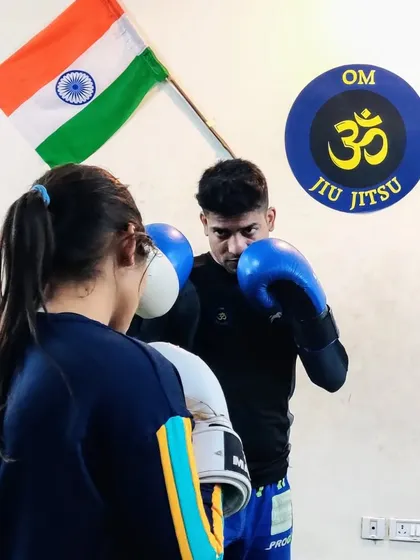 Practicing basic boxing drills with a student. Learning how to properly make a fist, punch, and move your feet is the foundation of effective striking for self-defense.