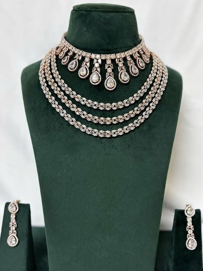 A multi-layered American diamond necklace set with a delicate design. This rental set is perfect for creating a sophisticated and glamorous look.