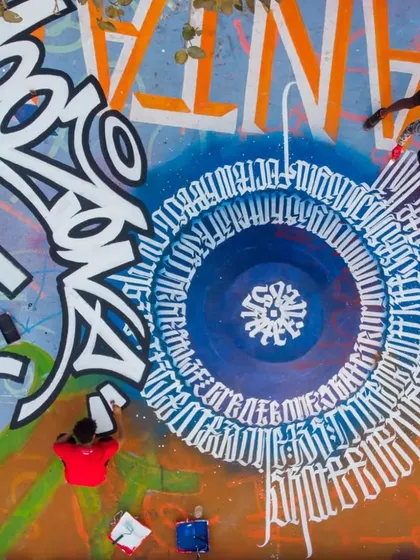 An aerial drone shot of a massive floor mural I collaborated on at the Carter Road skatepark in Bandra. My 'Mooz' tag is the centerpiece of this section.