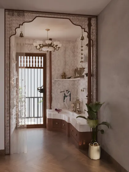 The mandir in this bedroom is framed by an ornate arch with intricate jali work. This sacred corner is designed as a seamless extension of the room's aesthetic, providing a space for quiet reflection within the personal sanctuary.