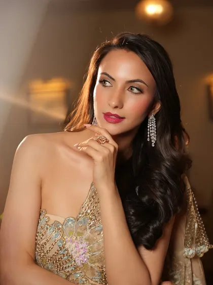 A thoughtful pose in the golden saree-gown. The styling is elegant and sophisticated, perfect for a high-profile event.