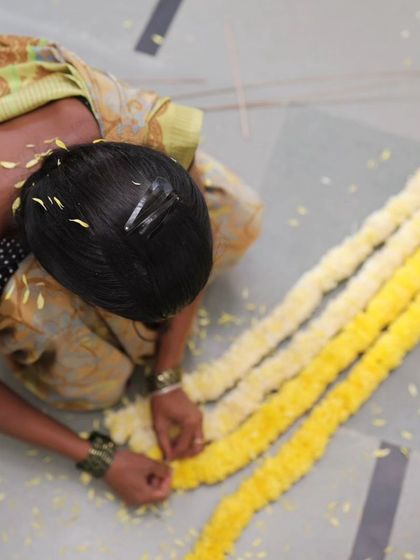 A close-up of the flower garland preparation.
