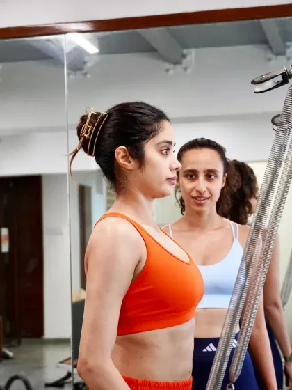 The connection between instructor and client is key to progress. Here, Namrata guides Janhvi Kapoor on the Cadillac, ensuring her form is precise and her muscles are engaging correctly for the most effective and safe workout.