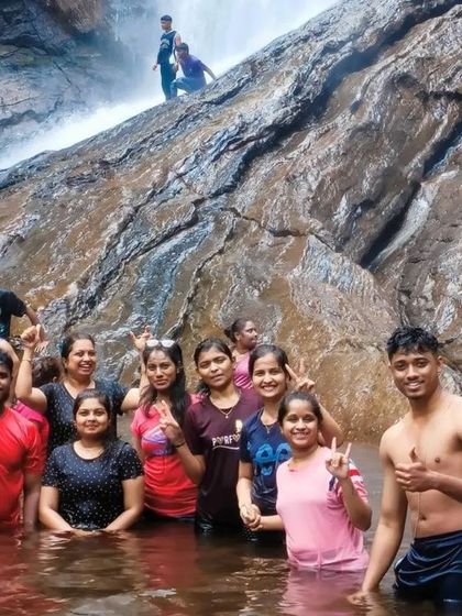 Friends enjoying a dip in the cool waters of a waterfall on our Chikmagalur trip.