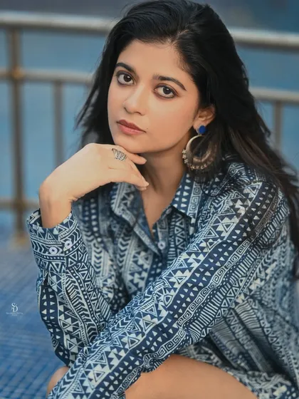 A close-up portrait of the model from the Sananda summer shoot. Her direct gaze and the interesting pattern of her dress make for a compelling and stylish image.
