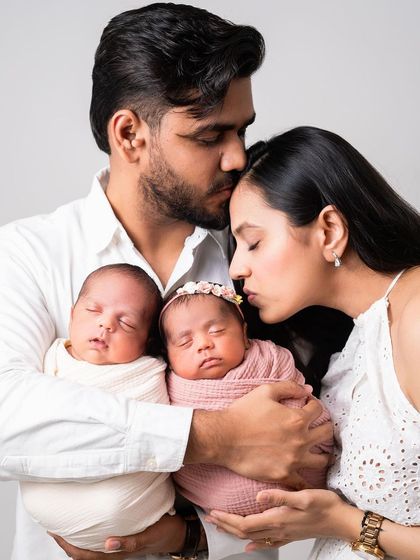 A beautiful portrait of a new family with their twin babies. My heart melts seeing so much love in one photo.
