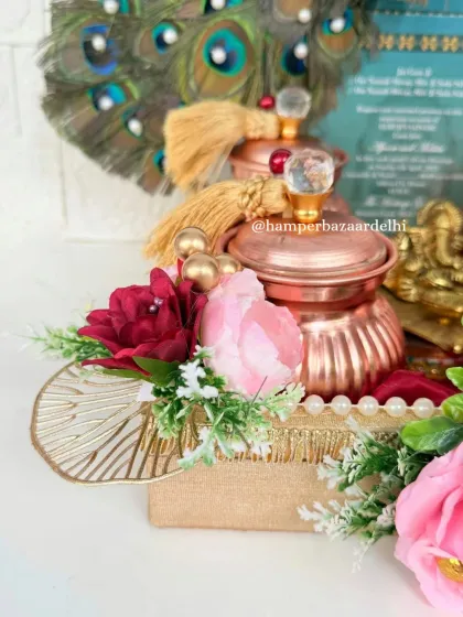 A close up of our luxurious wedding invitation hamper. The details are everything, from the floral embellishments to the crystal knobs on the metallic jars.
