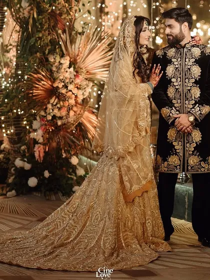A stunning reception look for singer Bismil and his bride. I styled him in a black velvet embroidered sherwani that exudes opulence, perfectly matching his bride's golden gown.