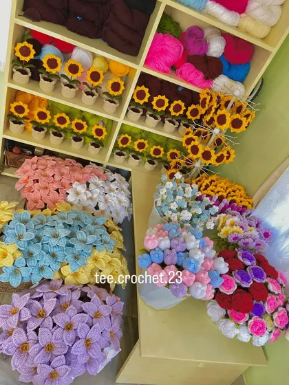An overhead shot of my workspace, with shelves of potted sunflowers and boxes of colorful flower stems.