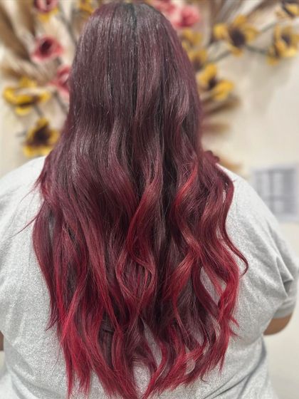 A full back view of the stunning red ombre, showcasing the length and beautiful wavy texture that makes the color pop.