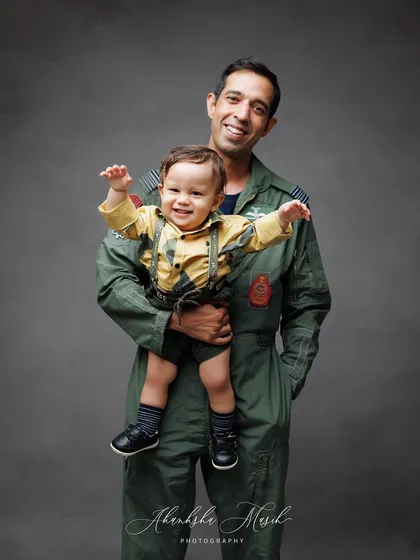 The pure delight in a father's arms. This image from a family session shows the joyful, playful bond between a dad and his son, a memory filled with laughter and love.