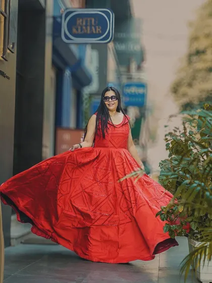 A final, joyful shot of the red dress in motion. This image is full of energy and is perfect for a celebratory or high-energy fashion post.