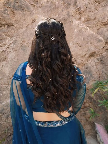 Another shot of the romantic half-up, half-down hairstyle with scattered pearls, perfect for an engagement or sangeet function.