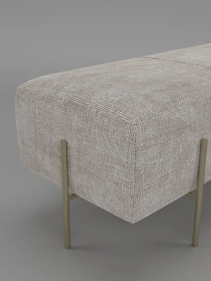 A close-up of the bench's corner, showing the fine-textured upholstery and the elegant design of the gold-finished metal legs.