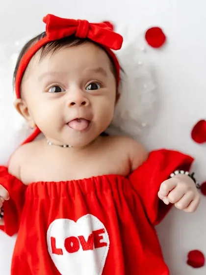 A playful moment from our Valentine's shoot, with the baby sticking her tongue out.