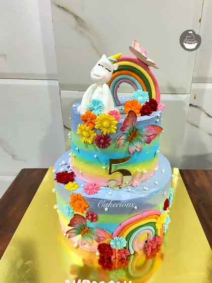 A different angle of the beautiful 4kg unicorn cake. The combination of rainbow stripes, flowers, and the unicorn topper makes it a truly magical centerpiece.