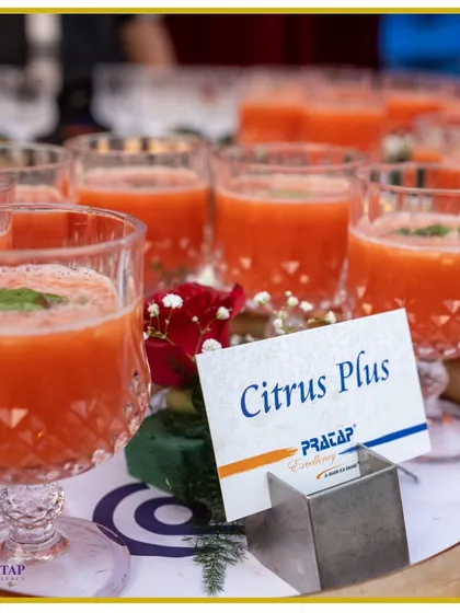A tray of our "Citrus Plus" mocktail, a tangy and refreshing fruit drink garnished with a mint leaf, served in elegant cut-glass tumblers.