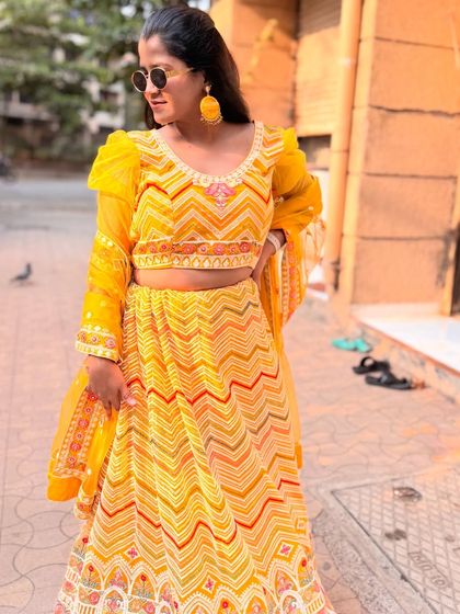 A full view of this gorgeous yellow lehenga with intricate patterns. It's a perfect choice for the bride or bridesmaids for a Haldi function.