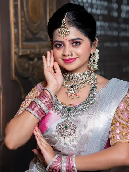 A beautiful reception look in a silver and pink saree, paired with diamond jewellery.